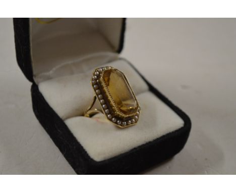 A yellow metal smoky quartz and seed pearl set ring