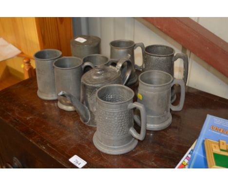 A quantity of various pewter tankards,a caddy and a teapot