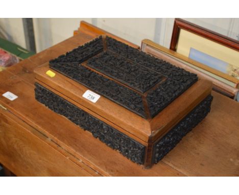 A hard wood trinket box with Eastern carved decoration 