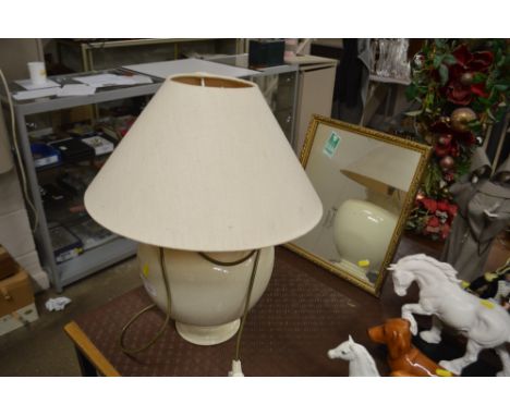 A crackle glazed baluster table lamp and shade; and a gilt framed easel mirror