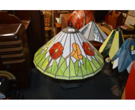 A Tiffany style table lamp with floral decorated shade 