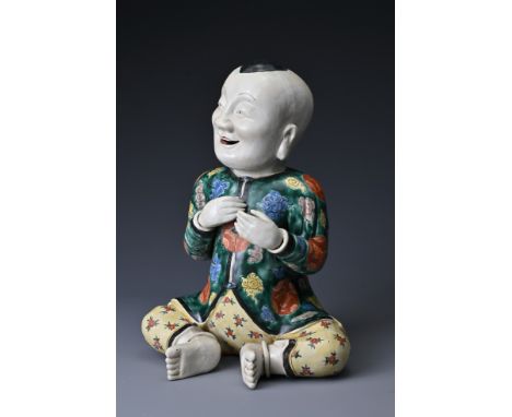A vintage Chinese polychrome ceramic figure of a boy. Height approx. 29 cm. 