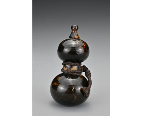 A Japanese amber and horn netsuke in the form of a double gourd. Meiji Period. Length 6cm.   Provenance: Purchased from Brian