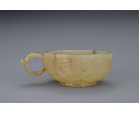 A Chinese 17/18th century jade wine cup with single Taotie mask form handle and 'rope twist' foot. 7.7cm length  Provenance: 