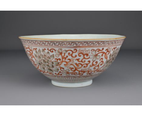 A Chinese 19th Century iron-red porcelain bowl decorated with scrolling peonies. The base with Jiaqing seal mark in underglaz