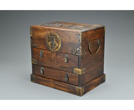 A Chinese hardwood seal chest. Of rectangular form carved in relief with qilin and shou mark. Top-opening with three drawers,