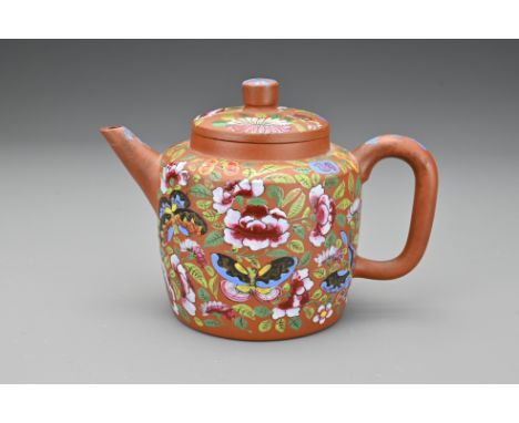 A Chinese Yixing pottery teapot with painted enamel decoration of flowers and butterflies. Signed 'Yi Gong' to base. 1766-183