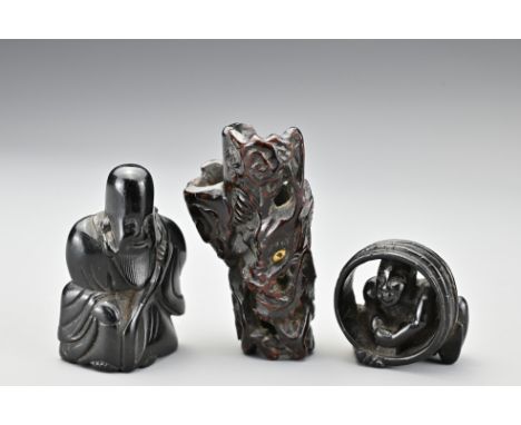 Three Japanese carved wood netsukes. To include a dragon amongst clouds with gilt eyes (unsigned). A carved wood netsuke of F
