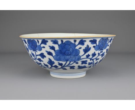 A Chinese early 19th Century blue and white porcelain bowl. The exterior decorated with scrolling peonies. The base with six-