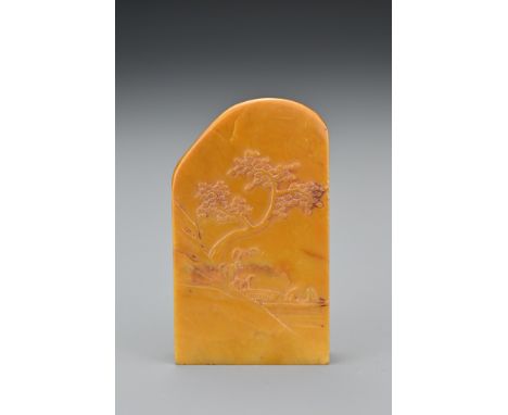 A Chinese soapstone seal. Carved in shallow relief of pine tree on the edge of a mountain with two figures in a boat. Height 