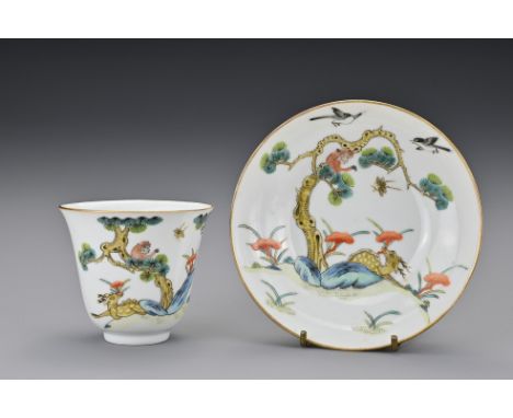 A Chinese porcelain enamelled cup and saucer. Painted with a monkey in a pine tree with deer holding lingzhi in it's mouth. B