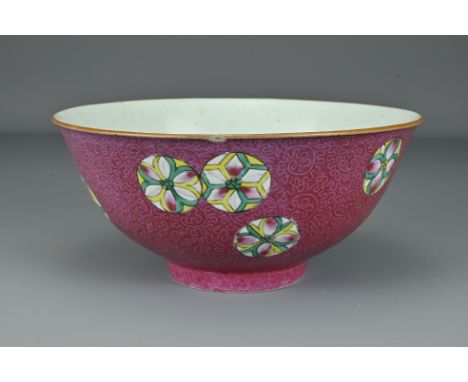 A Chinese early 19th Century sgraffito ruby-ground porcelain bowl. The exterior decorated with nine polychrome 'flower balls'