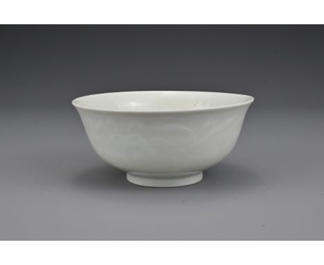 A Chinese white-glazed porcelain bowl with moulded lingzhi fungus decoration. The base with underglaze blue six-character sea