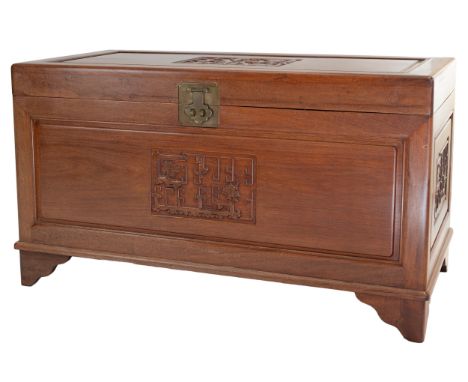 A Chinese carved camphorwood chest with sliding shelf inside, metal mounts and lock and key. Height 59 x width 101 x depth 50