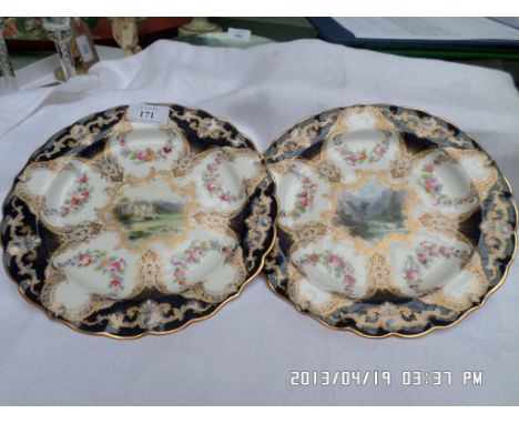2 decorative black and gilt surround Royal Worcester plates of similar size each inset rural scenes
