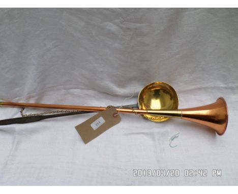 Brass and copper hunting horn and an iron handled brass ladle 
