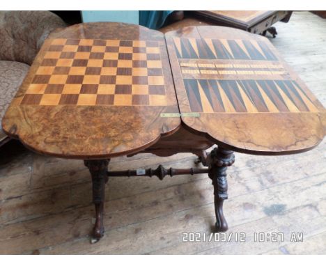 Fine example of a Victorian walnut games table, the swivel top revealing draughts, checkers and cribbage board with storage a