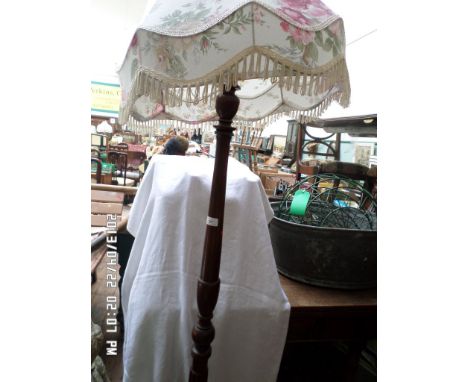 Mahogany standard lamp with tasselled floral patterned satin shade