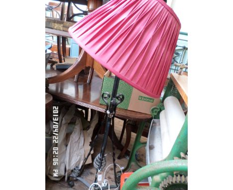 Wrought iron standard lamp with purple satin shade