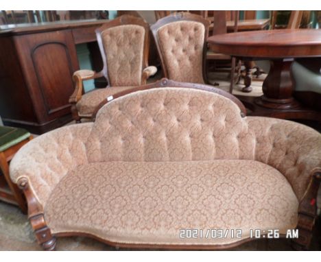 Three piece Edwardian boudoir suite, the button padded shaped backs of the settee and two chairs, each upholstered in matchin