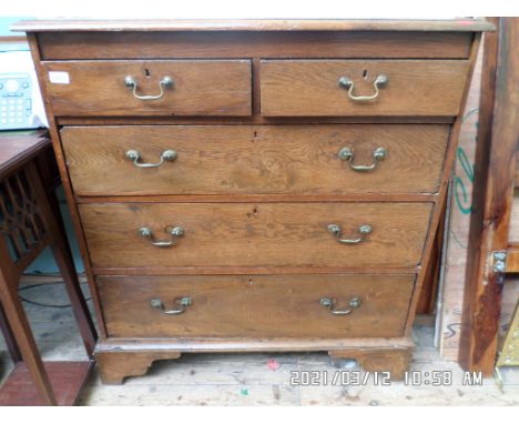 Oak chest of two short and three long graduated drawers, fitted brass drop handles all on bracket feet