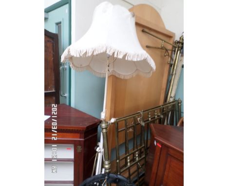 Wrought iron standard lamp with white tassel shade