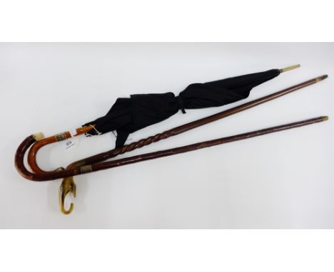 Vintage silver mounted umbrella, together with two walking canes, (3) 