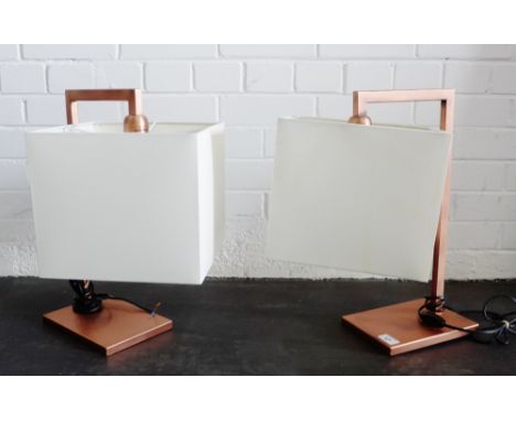 Pair of contemporary copper coloured metal lamp bases complete with cream shades, (2) 