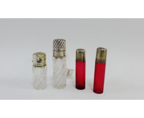 Four silver topped scent flask bottles to include two cranberry glass examples, tallest 8cm high (4) 