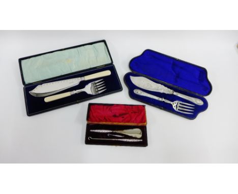 Two Epns fish serving sets together with a cased set of Chester silver handled button hooks and shoe horn (a lot)  