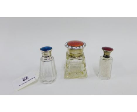 Three early 20th century silver and enamel topped bottles, tallest 6.5 cm, (3)  
