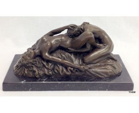 A bronze figure of ladies erotically entwined