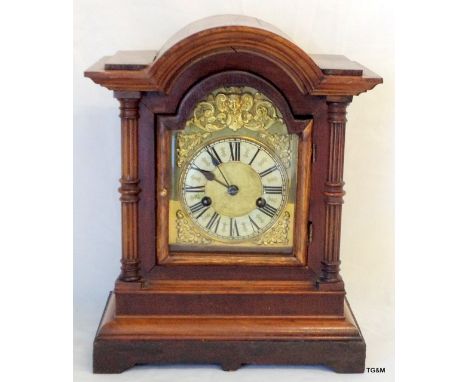 An Oak Mantle Clock fitted a German 2 Train movement striking on a gong with key and pendulum 36cm high