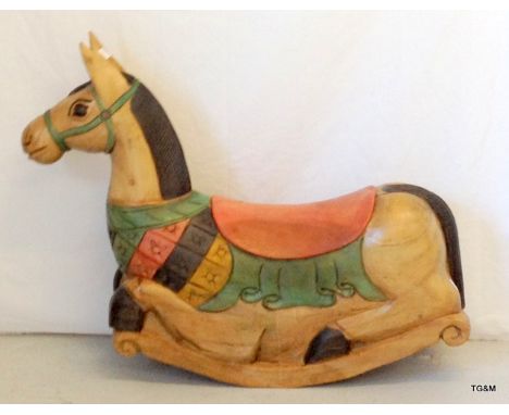 A wooden rocking horse 60cm high x 75cm long
