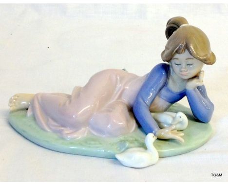 A Lladro figurine of a girl playing with ducks