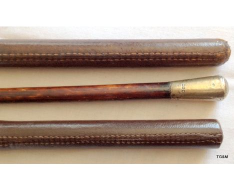 A 1914 hallmarked silver officers swagger stick with two other leather covered swagger sticks