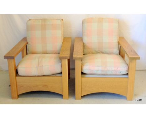A pair of solid light oak pool side reclining chairs 