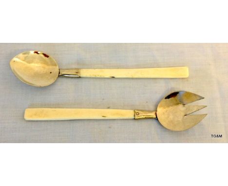 A hand beaten white metal and bone handled spoon and fork
