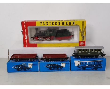 A boxed Fleischmann HO scale 4110 0-4-0 Locomotive and Tender and three boxed Marklin HO scale Wagons 