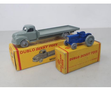 A boxed Dublo Dinky Toys 066 Bedford Flat Truck and 069 Tractor, mint. Both vehicles in mint condition, boxes excellent 