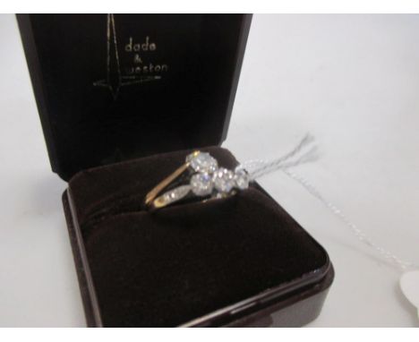 Two diamond rings; a single stone diamond ring, estimated weight 0.61cts, claw mounted in white metal to a plain yellow metal