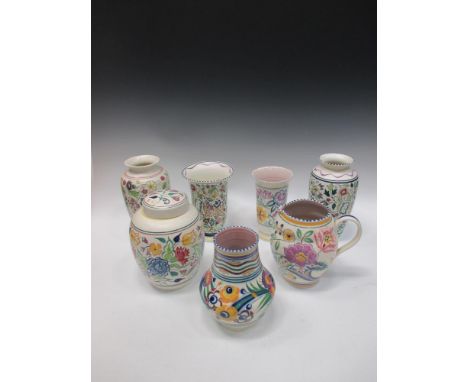 Seven poole pottery pieces to include a ginger jar, jug and vases  
