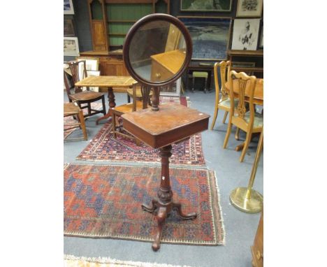A Victorian mahogany shaving stand with circular adjustable mirror, hinged lidded compartment to the mid tier on a fluted car