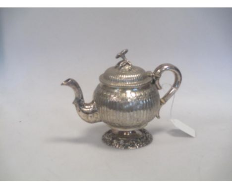 A Continental (probably Dutch) silver bachelor's teapot marks indistinct, of globular form, the body fluted below a foliate b