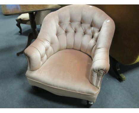 A Victorian nursing chair with fan shaped back, on turned legs, upholstered in modern needlework and a tub shaped button upho
