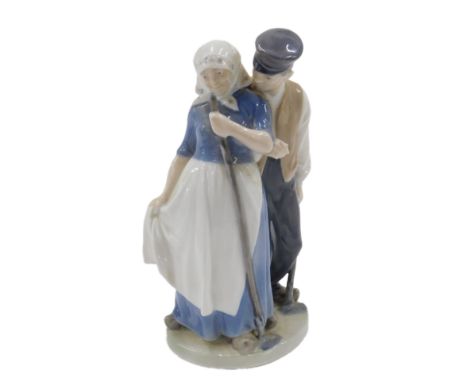 A Royal Copenhagen porcelain figure group of harvesters with hoes, printed marks and handwritten marks to underside, initials