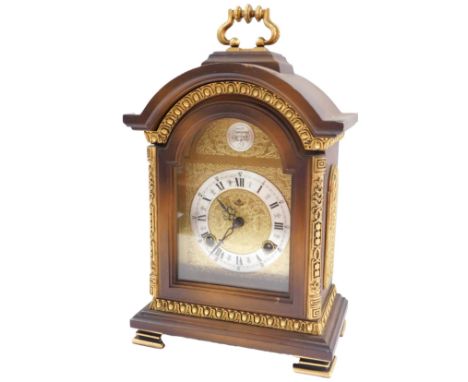 A mahogany and gilt mantel clock, the arched dial stamped Tempus Fugit, 27cm high. 