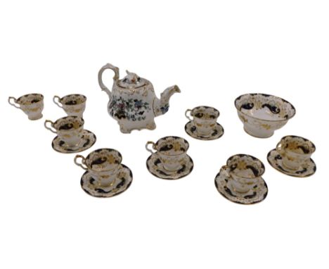 A 19thC English porcelain part tea service, decorated to the interior of the saucers and cups with a landscape surrounded by 