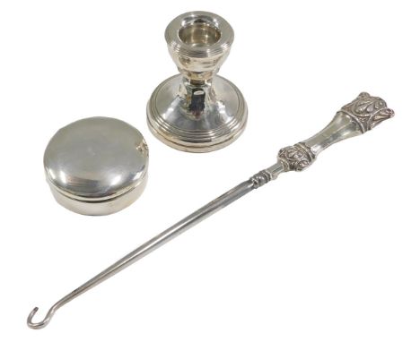 A George V silver pill box, Birmingham 1925, Elizabeth II loaded silver candlestick, Birmingham 1986, and an Edward VII silve
