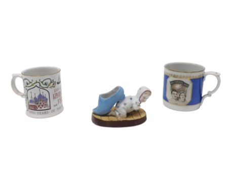 A Russian porcelain commemorative mug, decorated with two figures, printed marks in blue to underside, a Holkham ceramic mug,